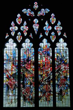 a large stained glass window with many different colors on it's windowsills