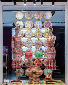 an assortment of decorative items on display in a store window