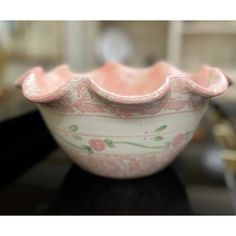 a pink and white bowl sitting on top of a table