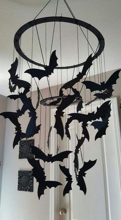 a wind chime with bats hanging from it's sides and on the ceiling