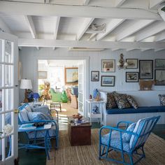 a living room filled with furniture and pictures on the wall