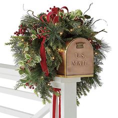 a mailbox decorated with christmas greenery and lights