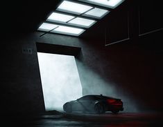 a car is parked in a dark room with light coming through the window and fog on the floor