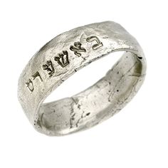 a silver ring with writing on it