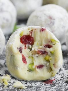 cranberry and pistachio truffles with powdered sugar on top