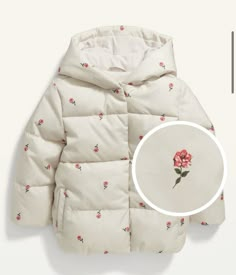 a white jacket with red flowers on it and a round object next to it that says,