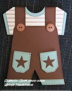 a paper doll with overalls and stars on it's chest, made to look like a baby boy