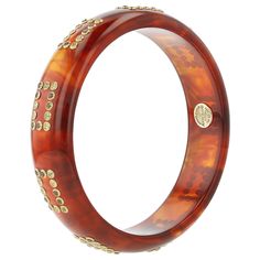 This elegant bangle was created using a warm, burnt orange, almost glowing, tortoise-colored bakelite. The gemstones have been mounted in a rectangular pattern that repeats nine times around the bangle. The gemstones used were selected especially for their muted colors. All gemstones have been bezel-set in 18k yellow gold. Metal 18-Karat Yellow Gold (Au750) Gemstones Mozambique Garnet 1.08 ctwPeridot 1.02 ctwSmoky Quartz 0.81 ctwYellow Sapphire 1.01 ctw Dimensions Inner Diameter 63.00 mm (2.48 i Bakelite Bangles, Tortoise Color, Muted Colors, Color Set, Bezel Setting, Ring Necklace, Burnt Orange, Gift Necklace, Tortoise