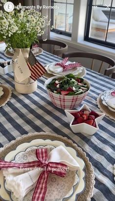 the table is set with plates, bowls and napkins for patriotic dinnereon party