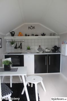 a small kitchen with black and white decor