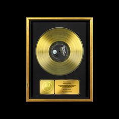 a gold record in a black frame