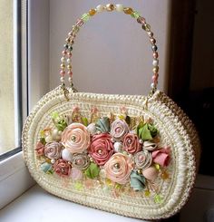 a white purse sitting on top of a window sill