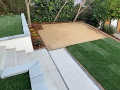 an outdoor area with grass, steps and trees