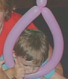 a woman holding a child in her arms with an inflatable ring around them