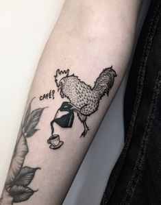 a tattoo on the arm of a woman with a rooster and coffee cup in it