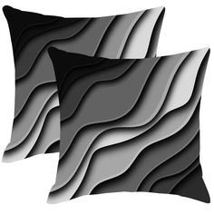 two black and white pillows sitting next to each other