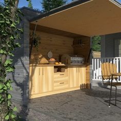 an outdoor kitchen is shown with chairs around it