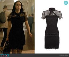 the vampire wears this black dress with sheer neck and lace detailing, which is worn by person