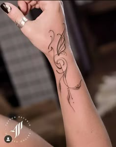 a woman's arm with a tattoo on it, and her hand in the air