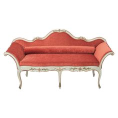 an old style couch with red upholstered cushions