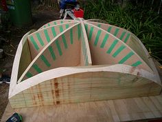 a wooden boat sitting on top of a piece of wood