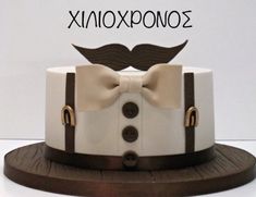 a white and brown cake with a bow tie