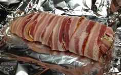 bacon wrapped in aluminum foil on top of a table