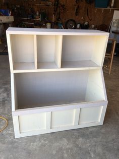 a white bookcase sitting inside of a garage