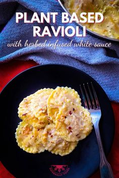 a black plate topped with ravioli next to a fork