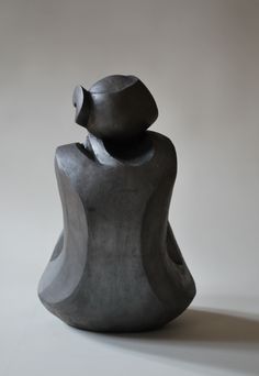 a gray sculpture sitting on top of a white table