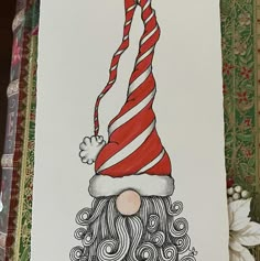 a drawing of a santa hat and beard with long red stripes on it's head