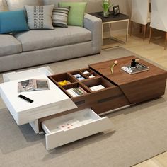 a living room with a couch, coffee table and other items on the floor in it