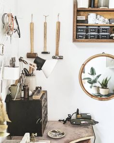 a room filled with lots of clutter and tools on the wall next to a mirror