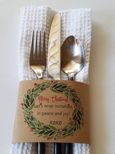 a napkin with a fork and spoon on it next to two forks, knife and spoon