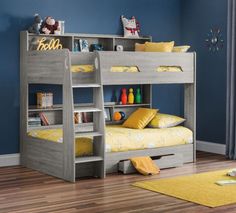 a child's bunk bed with yellow pillows and toys on the bottom bunk beds