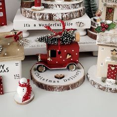 christmas decorations are stacked on top of each other in the shape of houses and trees