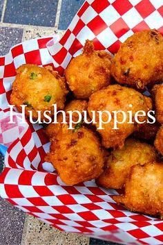 a basket filled with fried food sitting on top of a checkered paper wrapper