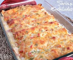 a casserole dish with cheese and other toppings in a glass baking dish