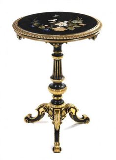 an ornately decorated table with black and gold trimmings on the top, against a white background