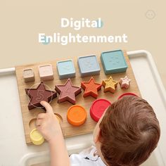 a young boy is playing with toys on a tray that says digital enlightening