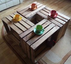 two cups are sitting on top of a wooden crate with one cup in the middle