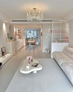 a living room filled with furniture and a chandelier