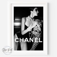 a black and white photo of a woman holding a cat with the words chanel on it