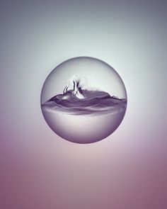 a glass ball with water in it floating on the surface