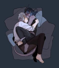 two people cuddling on a couch with one holding the other's head and hugging