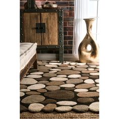 a rug with circles on it in front of a brick wall and floor lamp next to a window