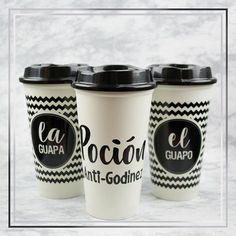 three coffee cups sitting next to each other on top of a white countertop with black lettering