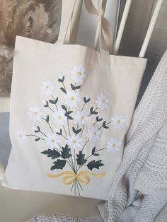 a tote bag with white flowers on it