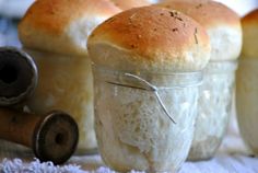 four rolls in a jar sitting on top of a table