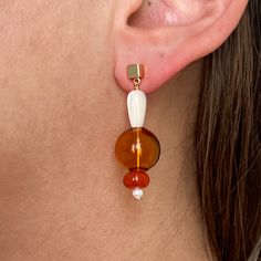 Featuring a combination of glass beading and natural stones, these contemporary earrings bring a hint of luxury to any ensemble. Made with neutral colors that complement any wardrobe, these earrings are the ultimate statement of refinement and elegance. Elegant Earrings With Colorful Beads For Gift, Modern Brown Jewelry For Parties, Elegant Amber Round Bead Earrings, Elegant Glass Drop Earrings, Chic Beaded Drop Earrings, Elegant White Beaded Earrings With Colorful Beads, Elegant Glass Dangle Jewelry, Elegant Dangle Glass Jewelry, Elegant Czech Glass Jewelry With Matching Earrings